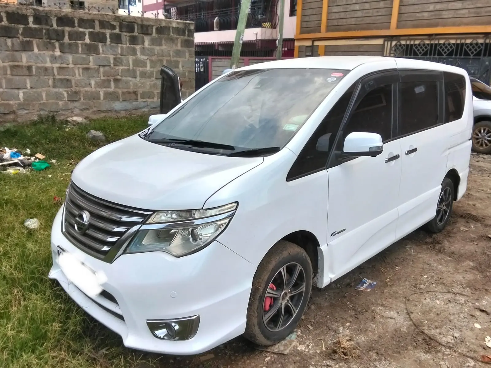 White Nissan Serena people carrier photographed from the front