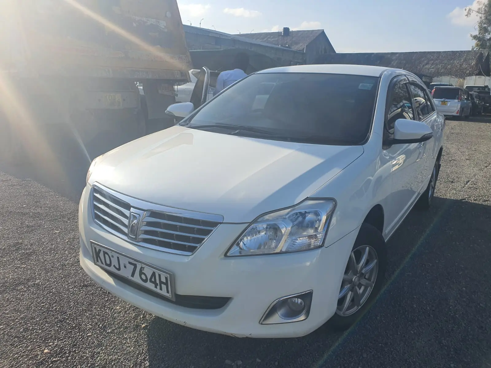 White Toyota Premio executive saloon photographed from the front
