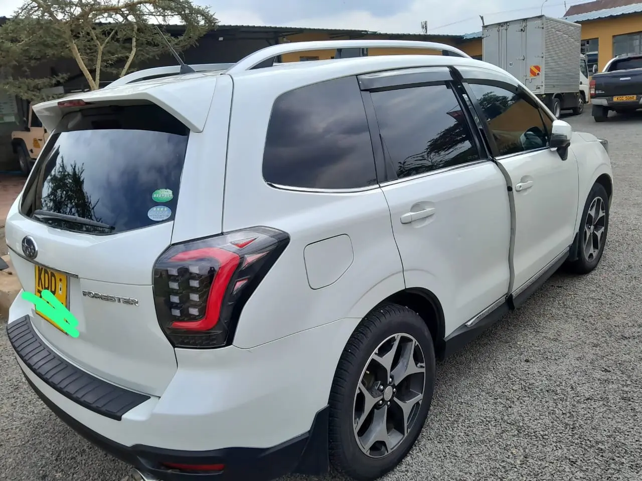 White Subaru Forester compact SUV photographed from the rear