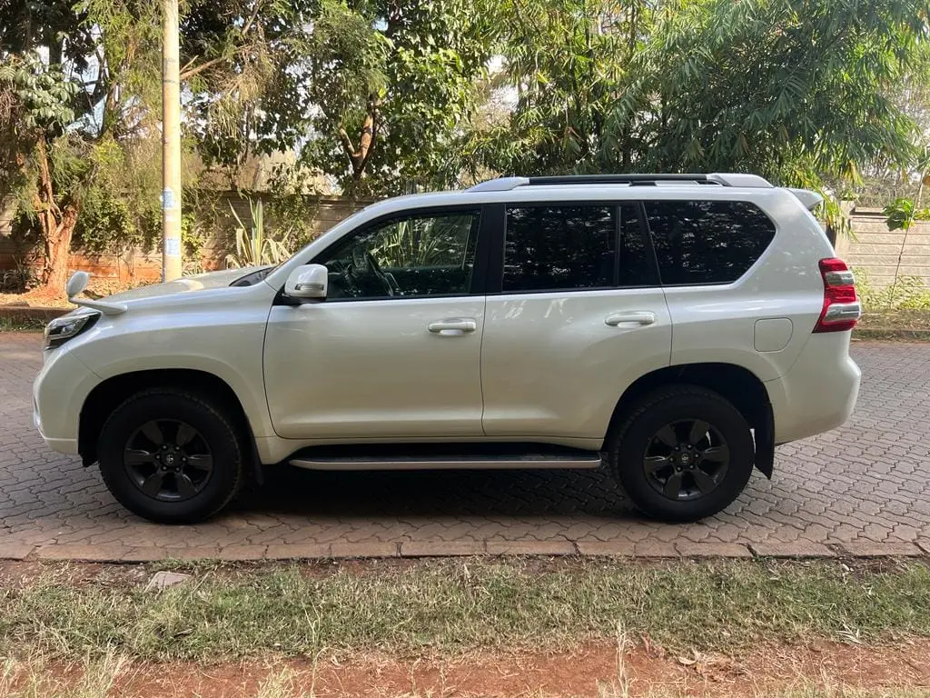 White Toyota Land Cruiser Prado photographed from the side